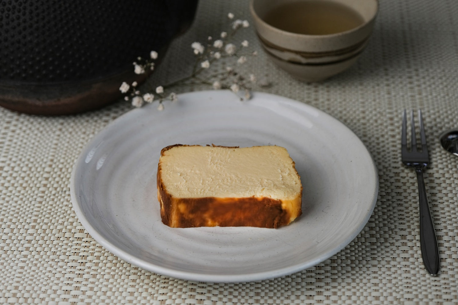 Ricotta Cheesecake on a white plate with flowers